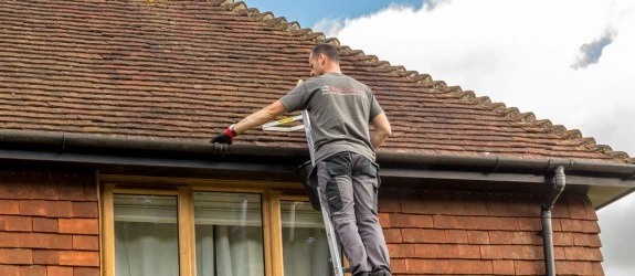 Gutter cleaning a residential property in Horley